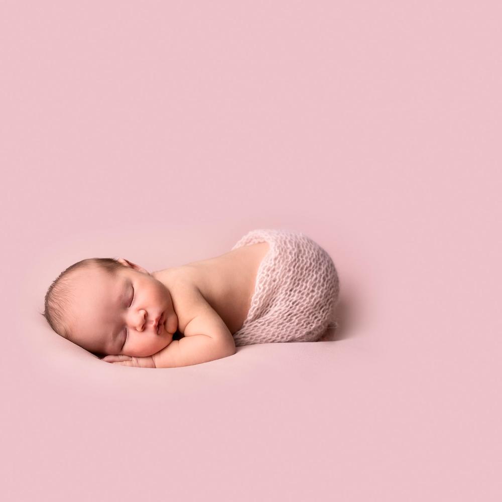 Newborn baby in roze setting